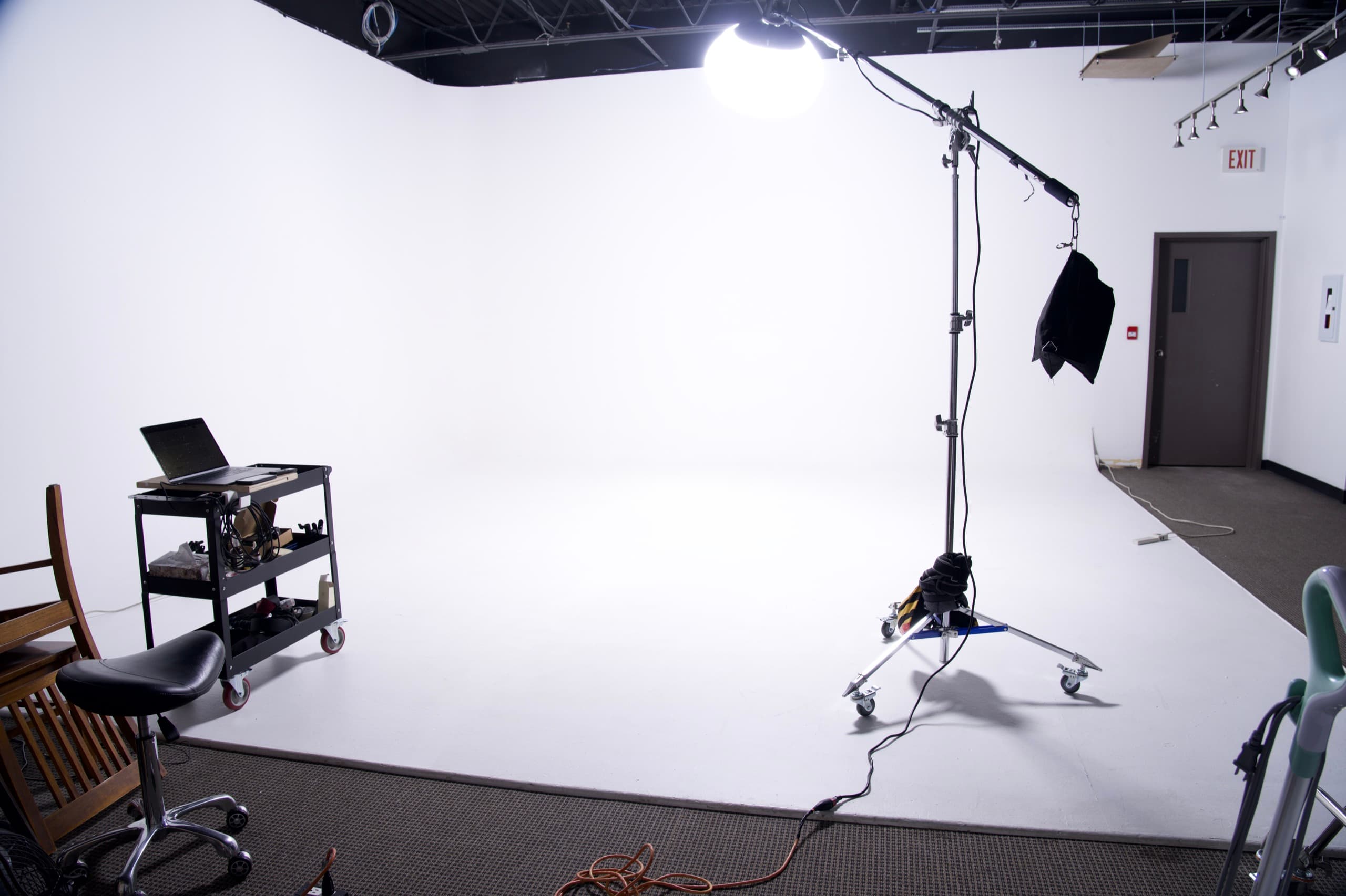 A lantern softbox on a boom arm lighting the cyc to pure white